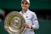 10 July 2021, United Kingdom, London: Australian tennis player Ashleigh Barty celebrates with the trophy after winning the women's singles final match against Czech Republic's Karolina Pliskova on day twelve of the 2021 Wimbledon Tennis Championships at The All England Lawn Tennis and Croquet Club. Photo: Steven Paston/PA Wire/dpa