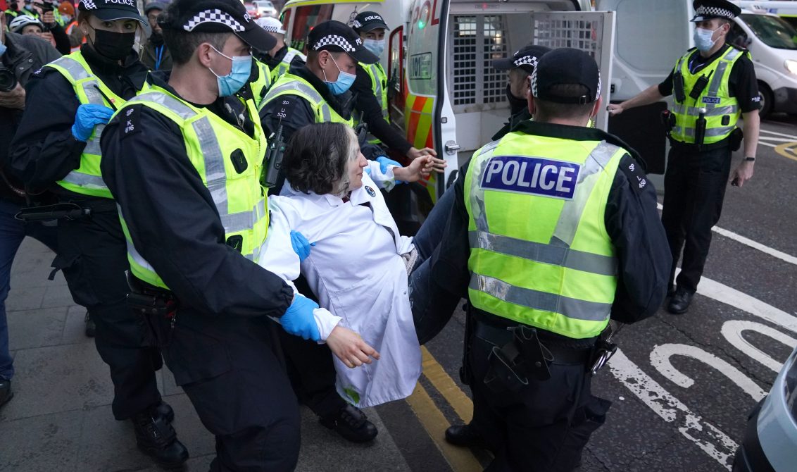 11 November 2021, United Kingdom, Glasgow: A climate protestor is removed and arrested by police during a demonstration at the Scottish Power Building during the Cop26 summit in Glasgow. Photo: Andrew Milligan/PA Wire/dpa