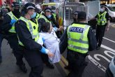 11 November 2021, United Kingdom, Glasgow: A climate protestor is removed and arrested by police during a demonstration at the Scottish Power Building during the Cop26 summit in Glasgow. Photo: Andrew Milligan/PA Wire/dpa