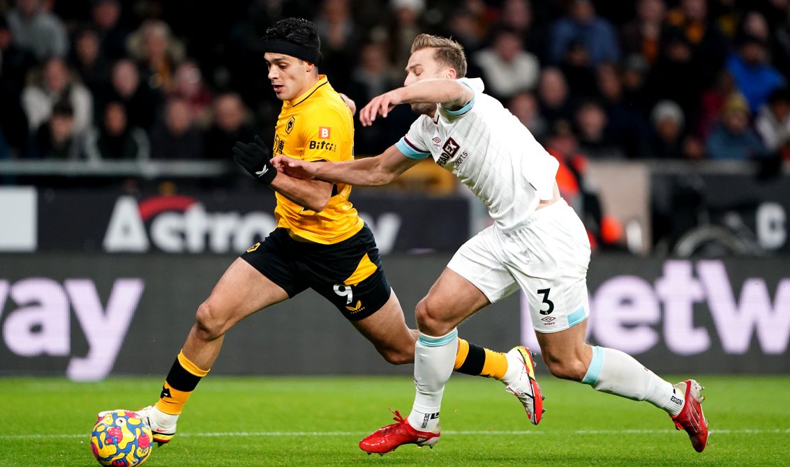 01 December 2021, United Kingdom, Wolverhampton: Wolverhampton Wanderers' Raul Jimenez (L) and Burnley's Charlie Taylor battle for the ball during the English Premier League soccer match between Wolverhampton Wanderers and Burnley at Molineux Stadium. Photo: Zac Goodwin/PA Wire/dpa