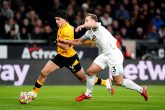 01 December 2021, United Kingdom, Wolverhampton: Wolverhampton Wanderers' Raul Jimenez (L) and Burnley's Charlie Taylor battle for the ball during the English Premier League soccer match between Wolverhampton Wanderers and Burnley at Molineux Stadium. Photo: Zac Goodwin/PA Wire/dpa