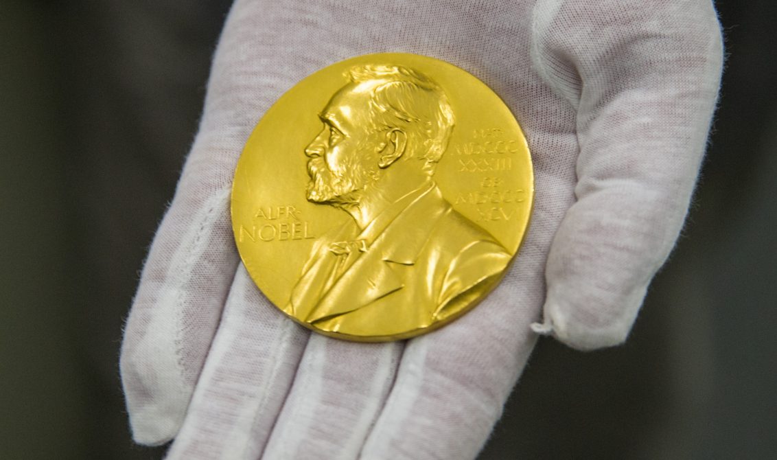 FILED - 29 February 2016, Bavaria, Munich: Wilhelm Fuessl, director of the archive of the Deutsches Museum, holds a Nobel Prize medal. Photo: picture alliance / dpa