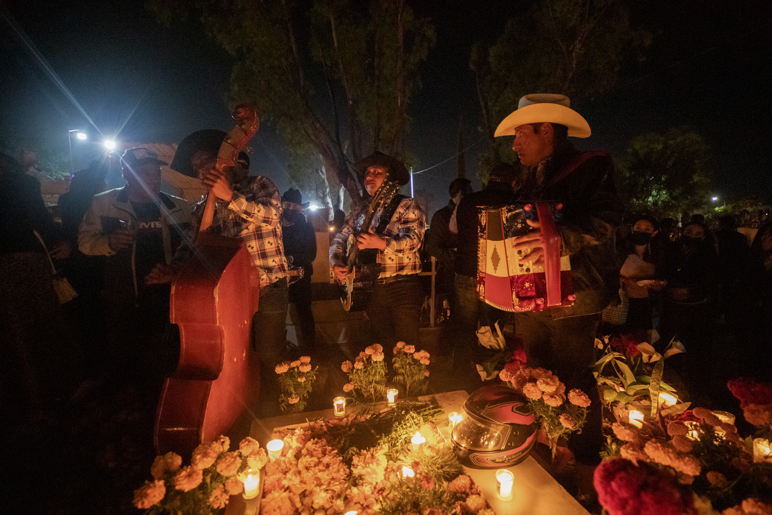 31 October 2022, Mexico, Oaxaca: People play music at a decorated cemetery on All Saints' Day which celebrates the Day of the Dead. Photo: Felipe Perez/dpa