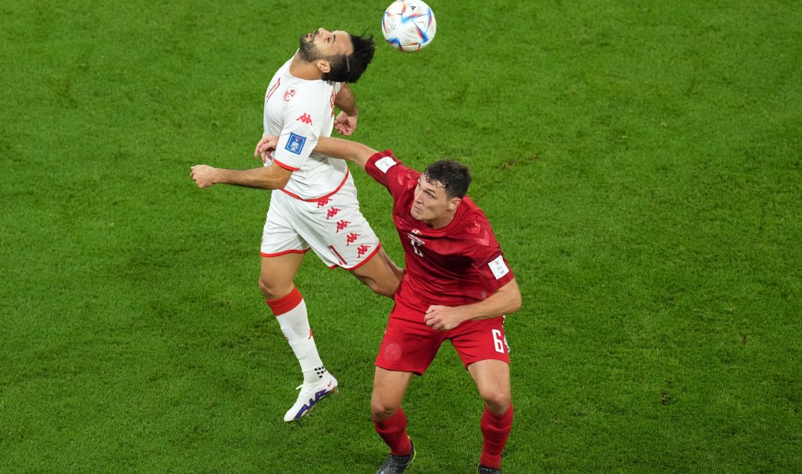 22 November 2022, Qatar, Al Rayyan: Tunisia's Taha Yassine Khenissi (L) and Denmark's Andreas Christensen battle for the ball during the FIFA World Cup Qatar 2022 Group D soccer match between Denmark and Tunisia at the Education City Stadium. Photo: Martin Rickett/PA Wire/dpa
