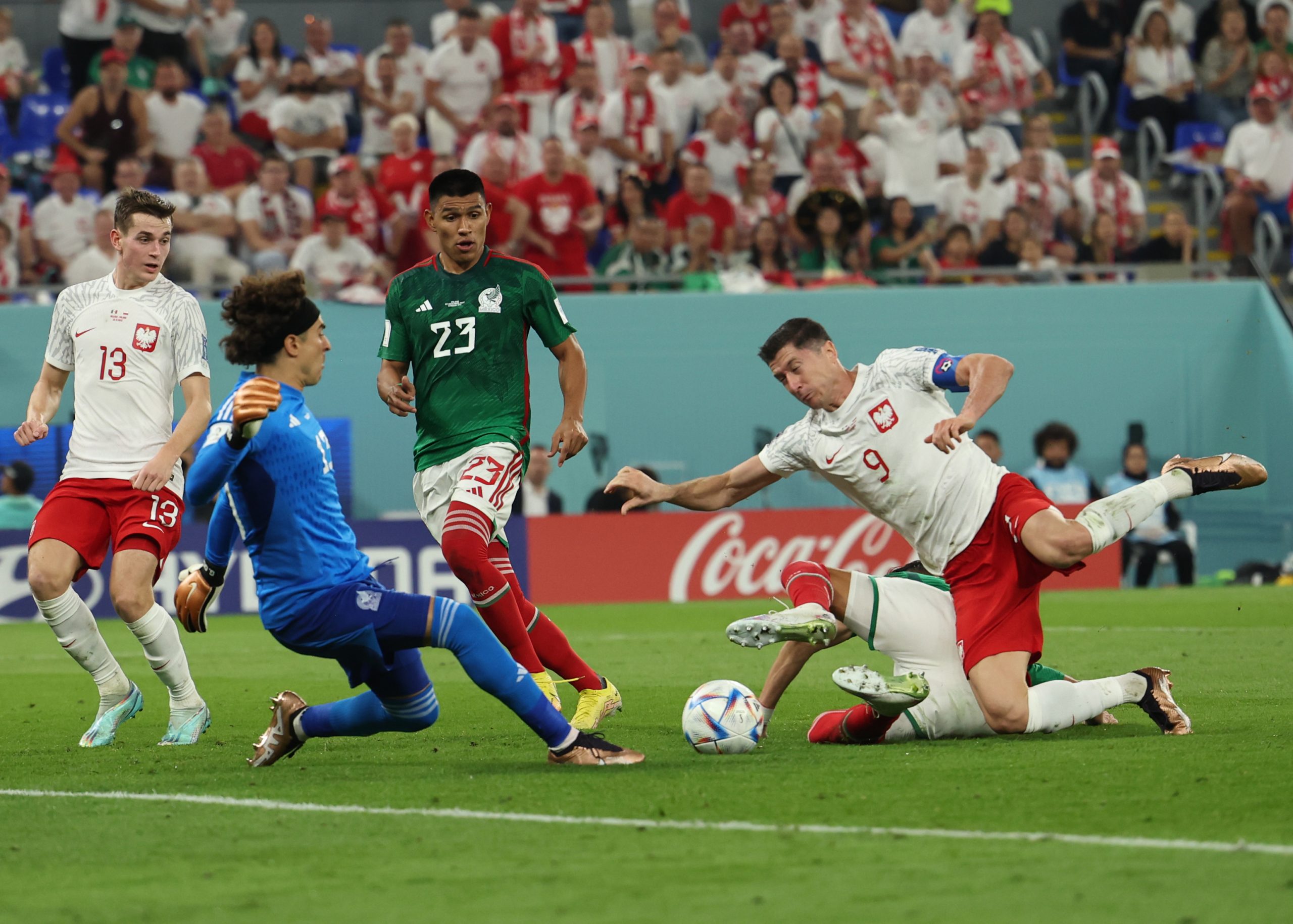 22 November 2022, Qatar, Doha: Poland's Robert Lewandowski (R) is fouled by Mexico's Hector Moreno (covered) in the penalty area during the FIFA World Cup Qatar 2022 Group C soccer match between Mexico and Poland at Stadium 974. Photo: Christian Charisius/dpa