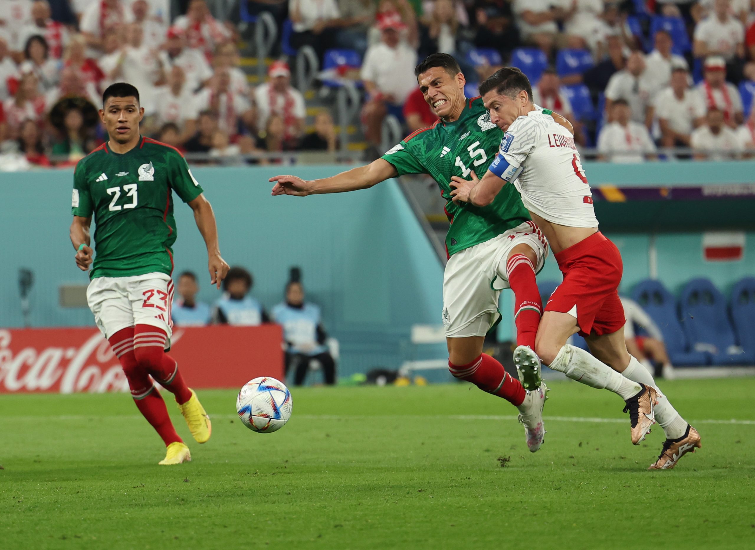 22 November 2022, Qatar, Doha: Poland's Robert Lewandowski (R) is fouled by Mexico's Hector Moreno in the penalty area during the FIFA World Cup Qatar 2022 Group C soccer match between Mexico and Poland at Stadium 974. Photo: Christian Charisius/dpa