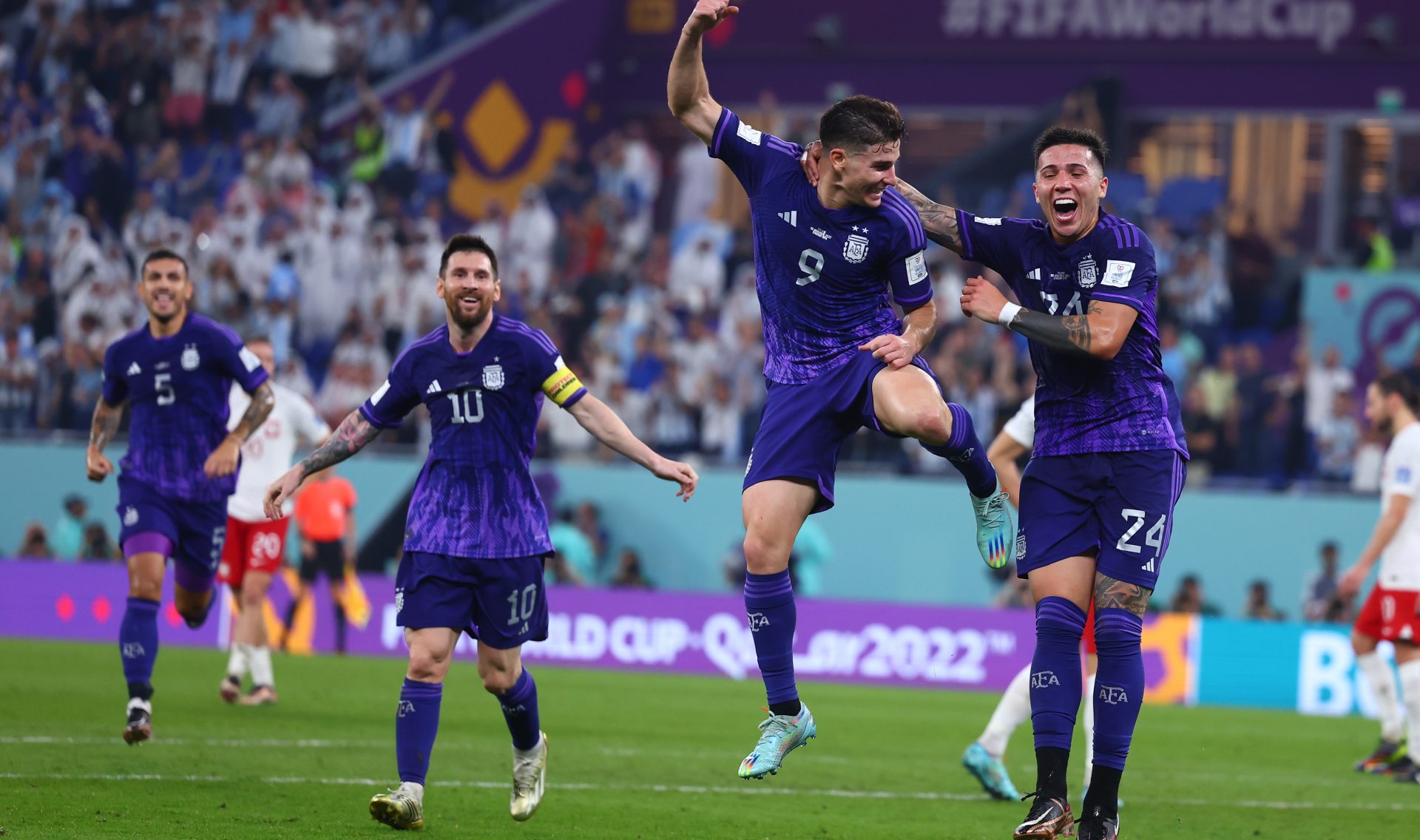 30 November 2022, Qatar, Doha: Argentina's Julian Alvarez (C) celebrates scoring his side's second goal with teammates Enzo Fernandez (R) and Lionell Messi during the FIFA World Cup Qatar 2022 Group C soccer match between Poland and Argentina at Stadium 974. Photo: Tom Weller/dpa