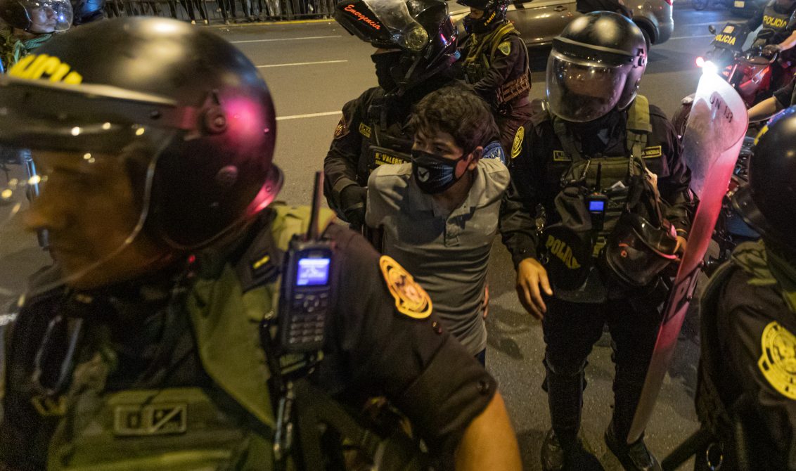 15 December 2022, Peru, Lima: Police officers detain a young man during a demonstration. People have died in various parts of Peru during increasingly violent protests against the ouster of President Castillo, according to government sources. Thousands of people demanded the resignation of Castillo's successor Boluarte as well as the dissolution of parliament, early new elections and the release of the imprisoned ex-president. Photo: Lucas Aguayo Araos/dpa
