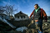 29 December 2022, Ukraine, Stepne: A man stands outside a house destroyed in a Russian S-300 missile attack on Stepne village. Photo: -/Ukrinform/dpa